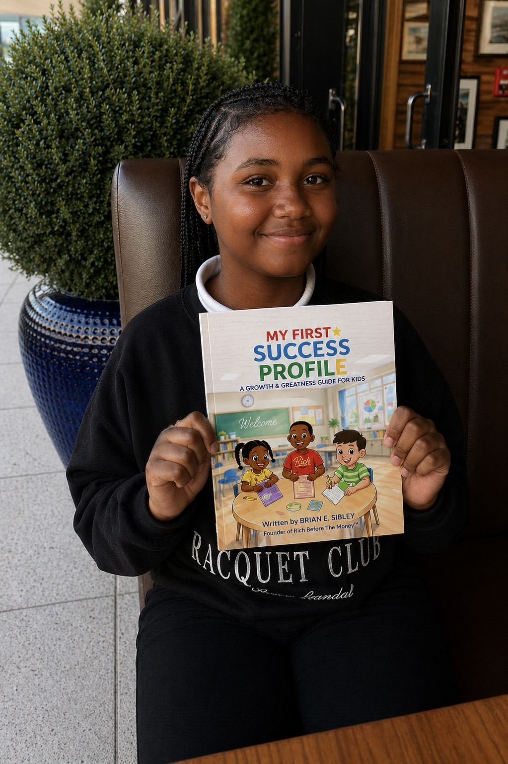 A young reader holding My First Success Profile