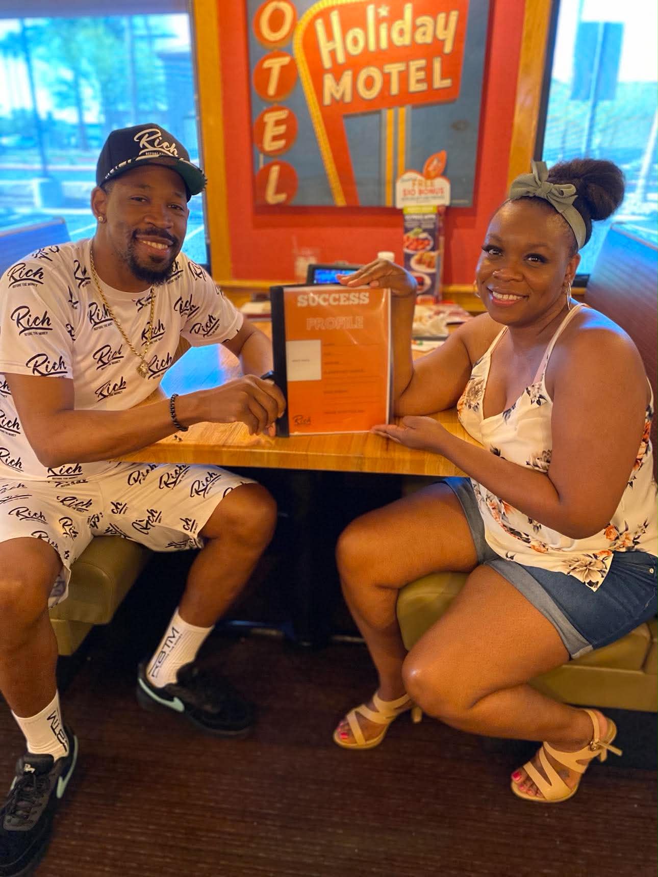 Brian E. Sibley and Jennece Black holding an early Success Profile prototype at a diner