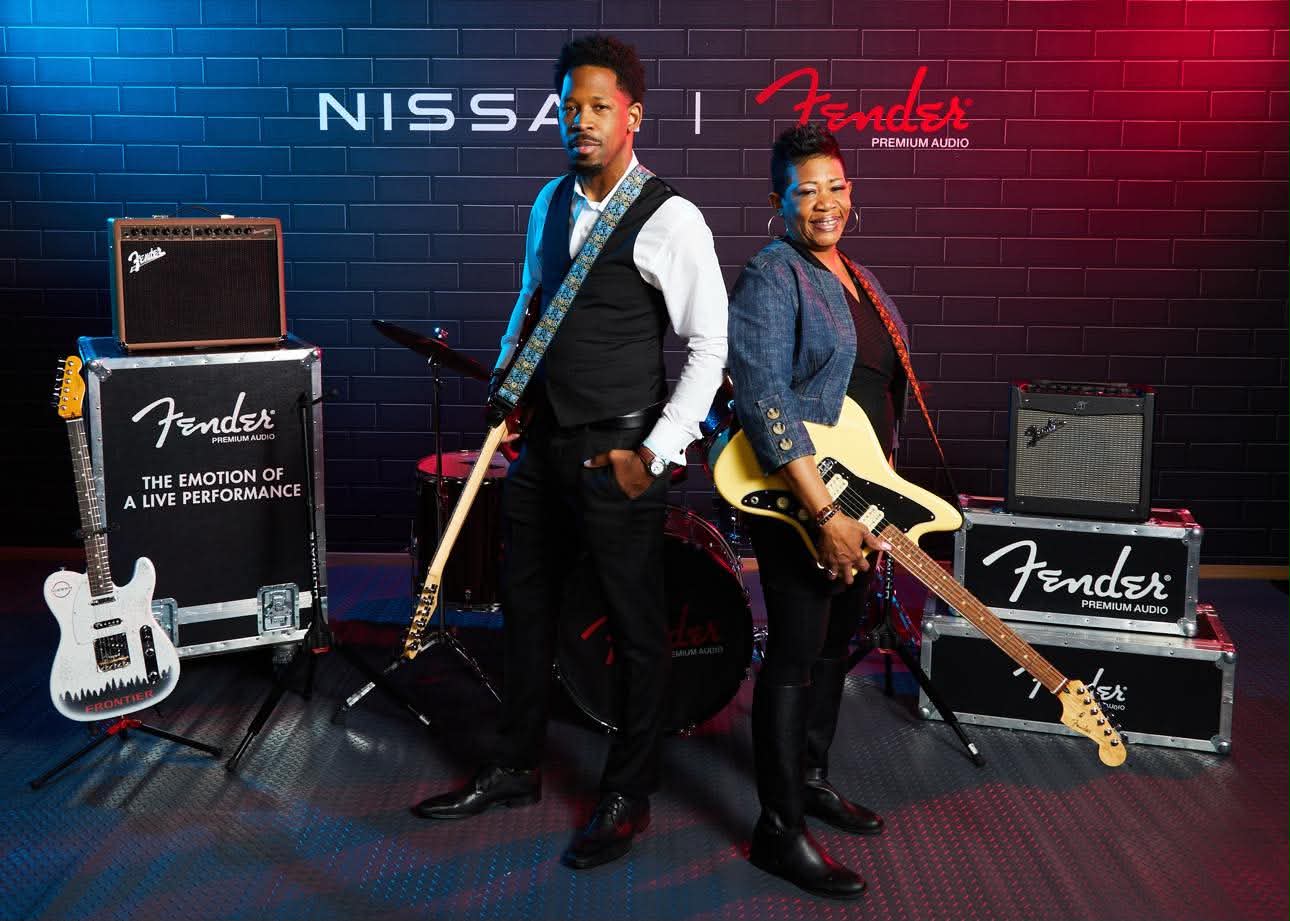 Brian E. Sibley and his mother holding guitars at a Nissan and Fender auto show event