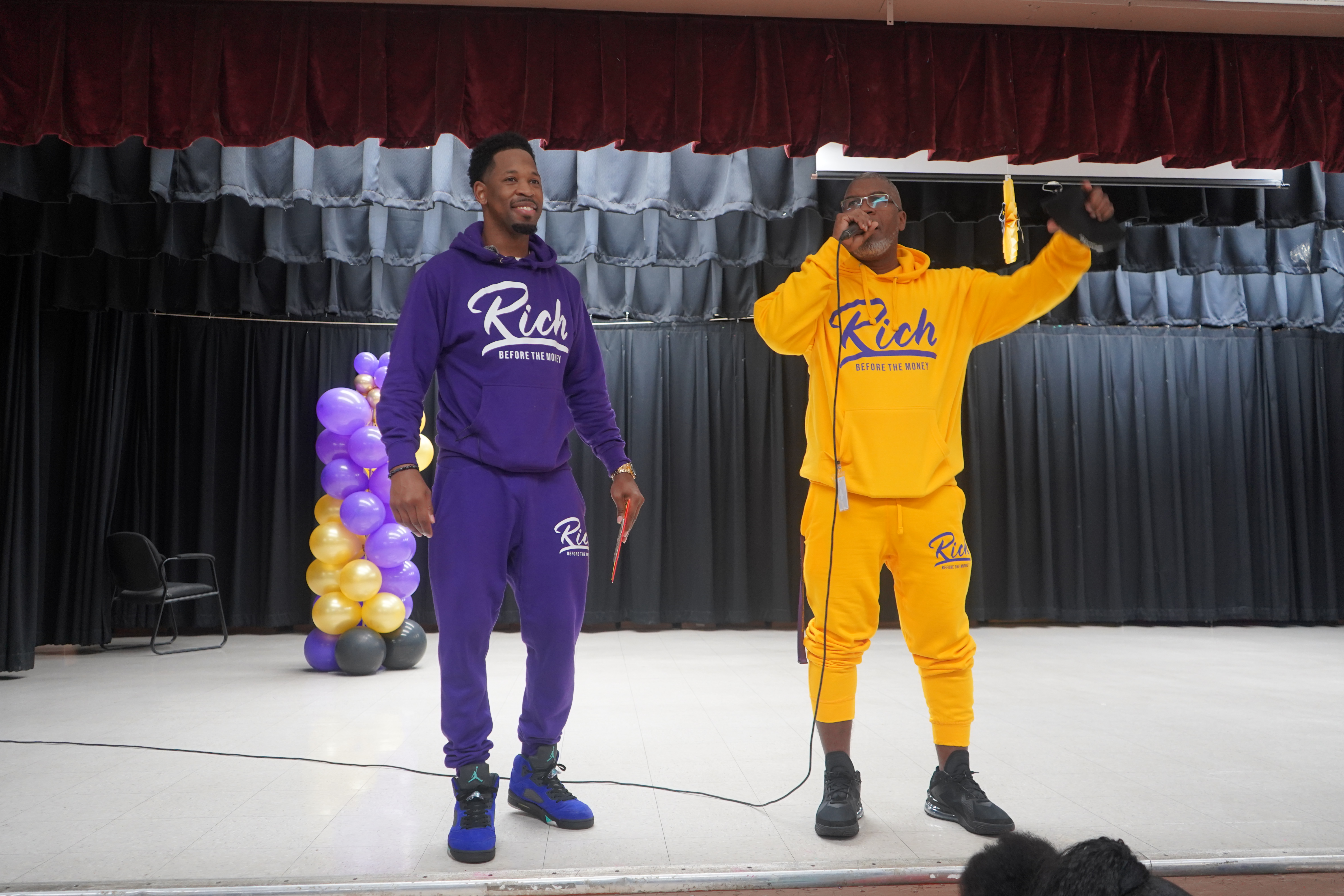 Brian E. Sibley on stage in Rich Before The Money apparel, Miami