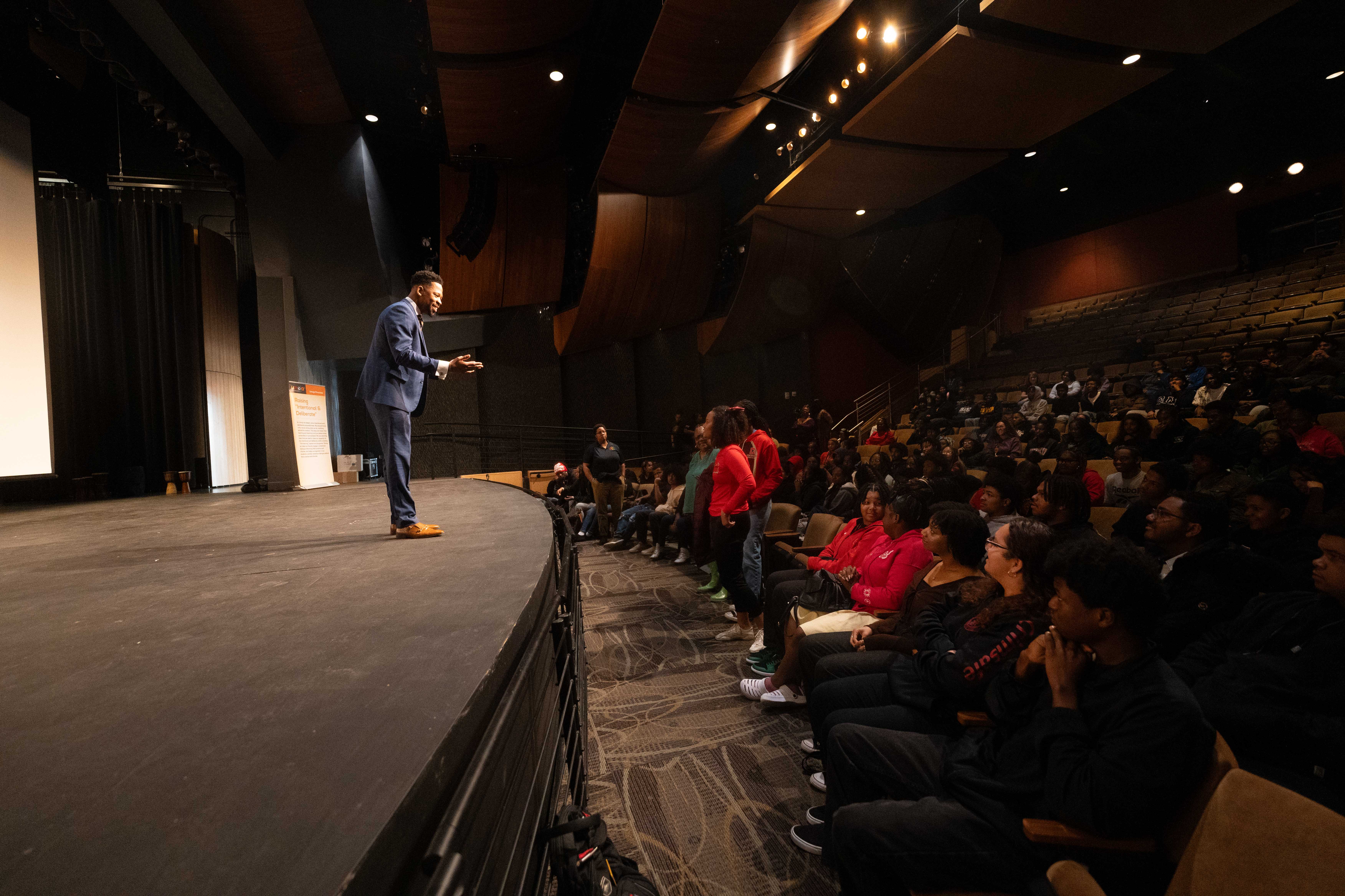 Brian E. Sibley on stage addressing students