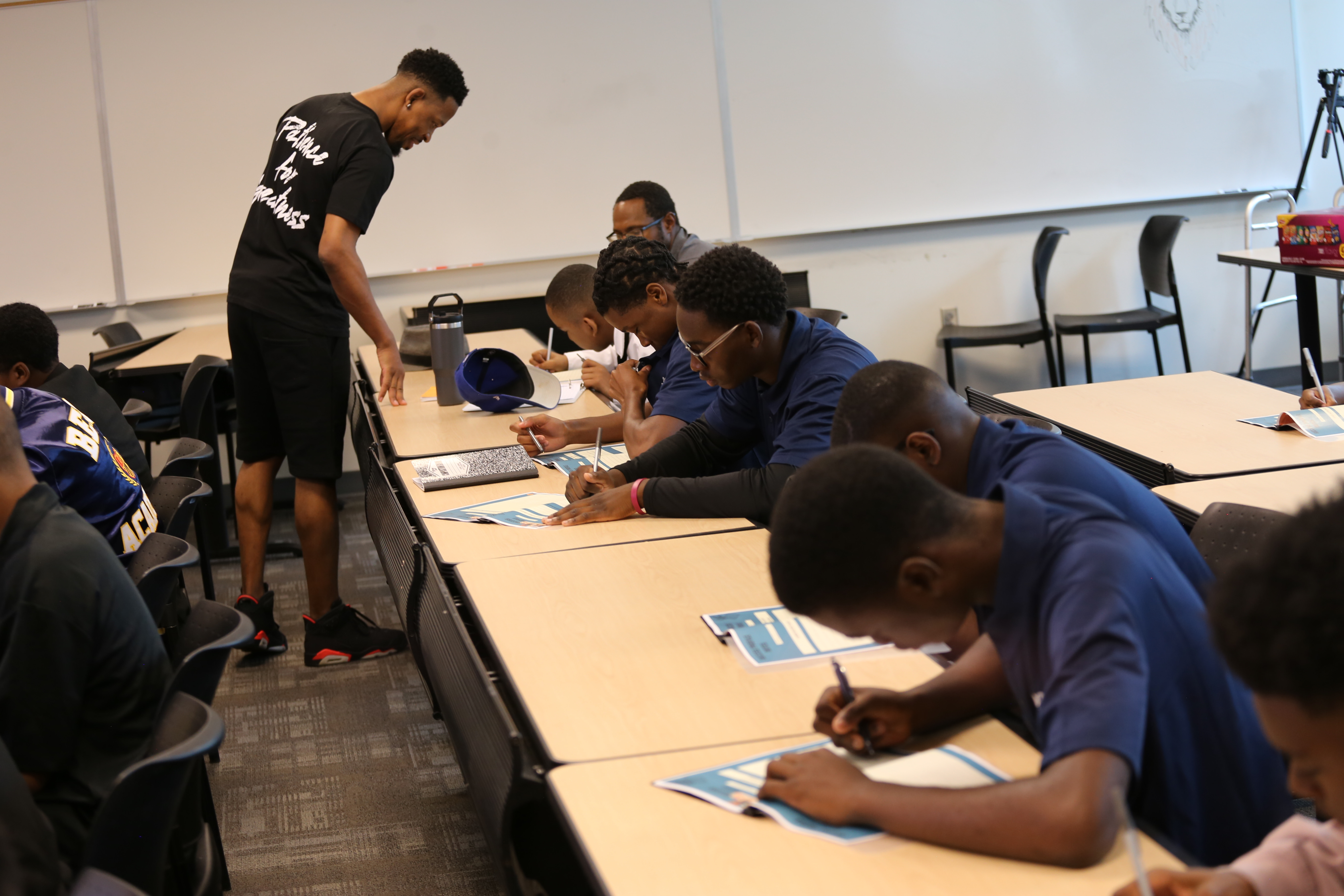 Young men writing in The Success Profile workbooks