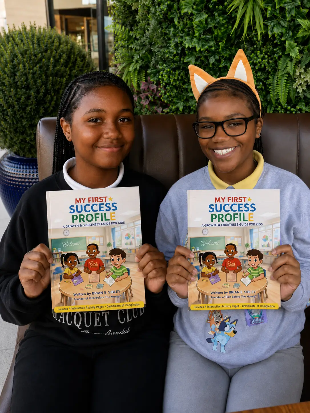 Girls with book holding My First Success Profile together